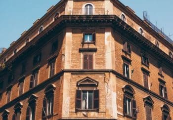 A stunning view of a historic building facade in Rome, Italy, under a clear blue sky.