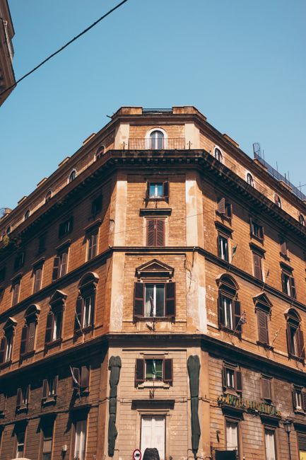 A stunning view of a historic building facade in Rome, Italy, under a clear blue sky.