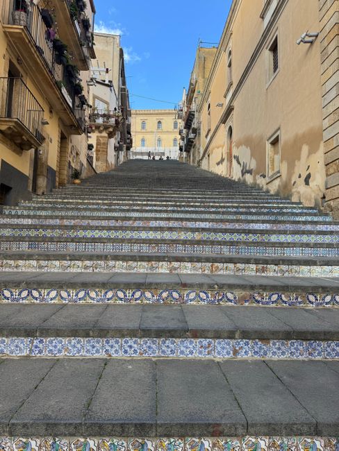 Captivating view of decorative tile staircase leading through historic Italian architecture.