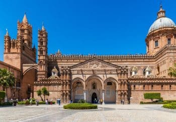 Explore the stunning architecture of Palermo Cathedral on a sunny day in Sicily.