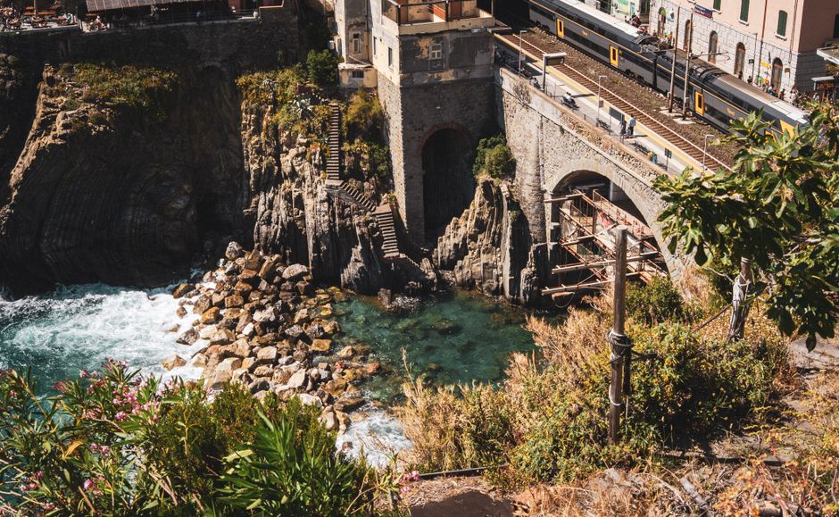 Idyllic view of Liguria coast with rocky cliffs and railway in Italy.