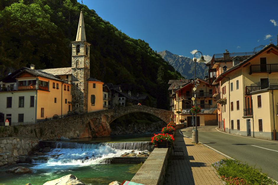 Idyllic view of medieval bridge and village in Fontainemore, Italy during summer.