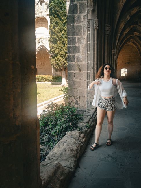 Woman wearing sunglasses and floral shorts exploring the historic architecture of Beylerbeyi.