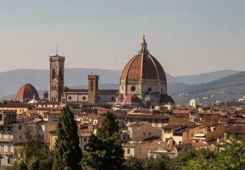 View of Florence's iconic Duomo against a backdrop of the Tuscan hills.