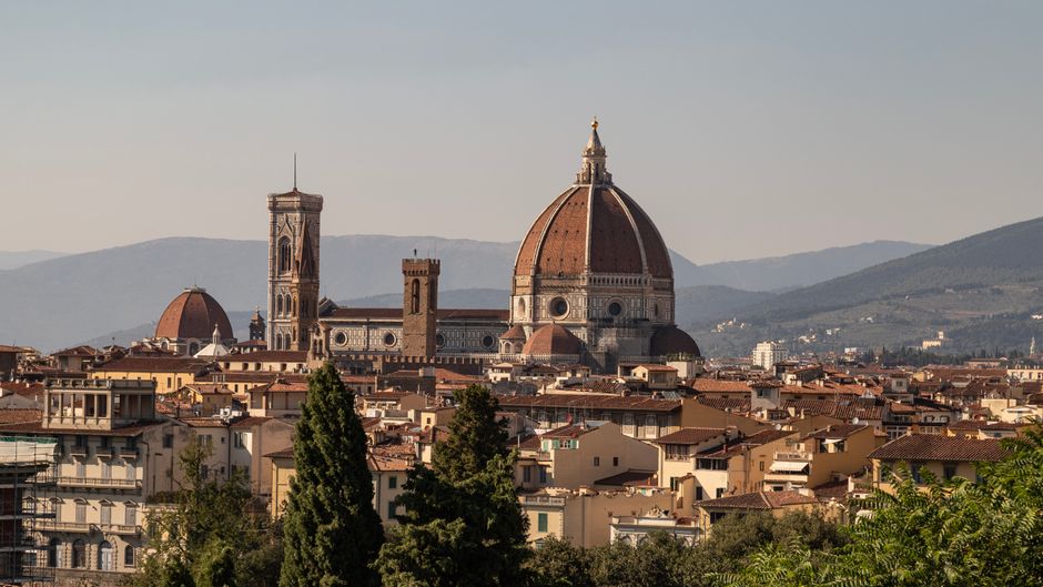 View of Florence's iconic Duomo against a backdrop of the Tuscan hills.