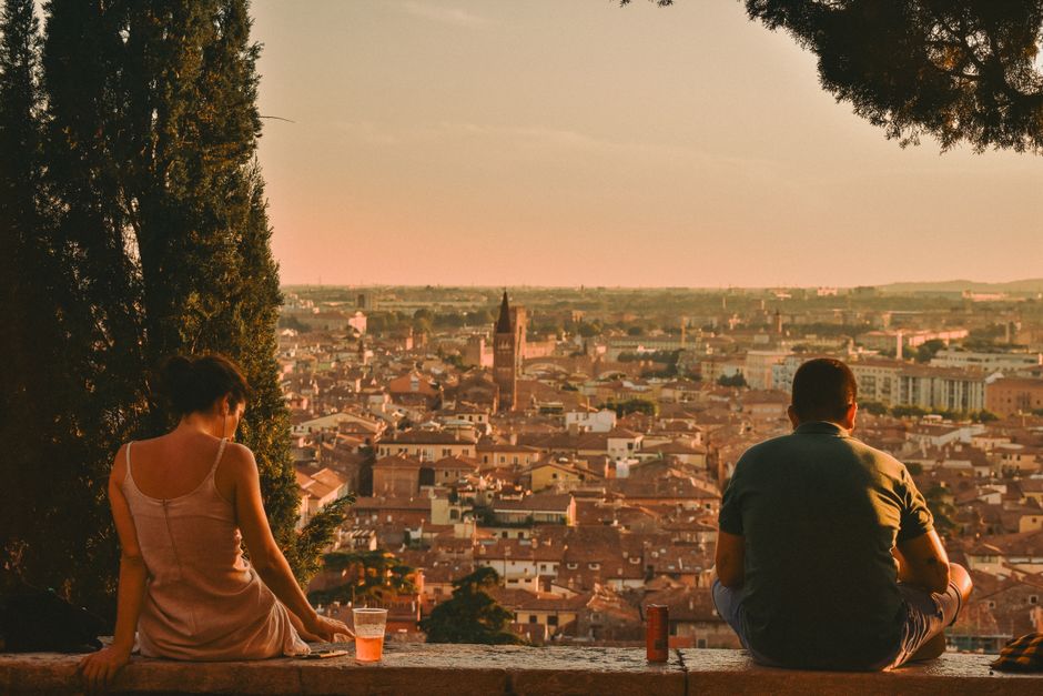 A couple enjoying the sunset view over Verona, Italy. Perfect for travel and lifestyle themes.