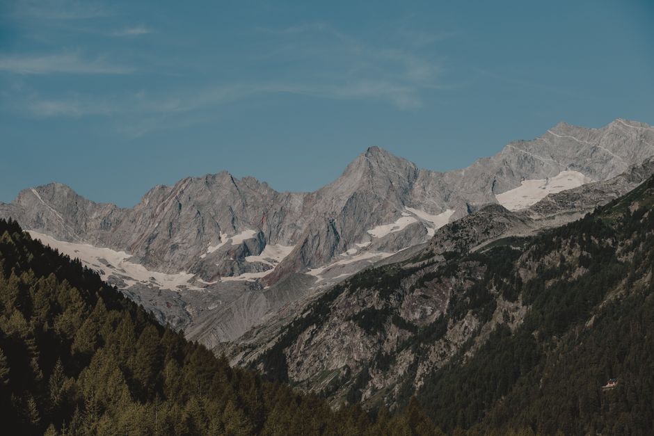 Breathtaking view of alpine mountains with snow under a clear blue sky.