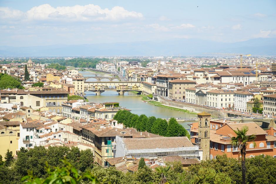 Breathtaking aerial view of Florence, Italy, showcasing the iconic Ponte Vecchio and surrounding architecture.