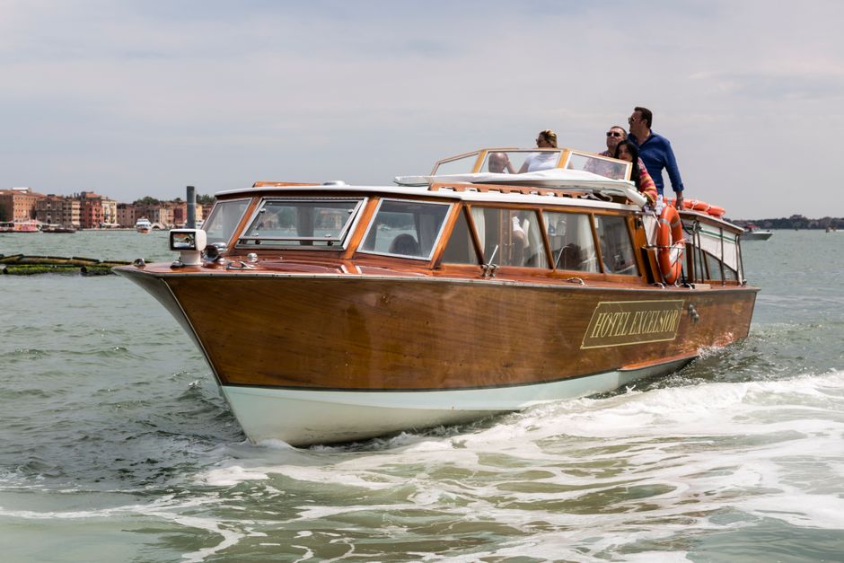 A group enjoying a scenic boat ride on a luxury water taxi in Venice, Italy's famous canals.