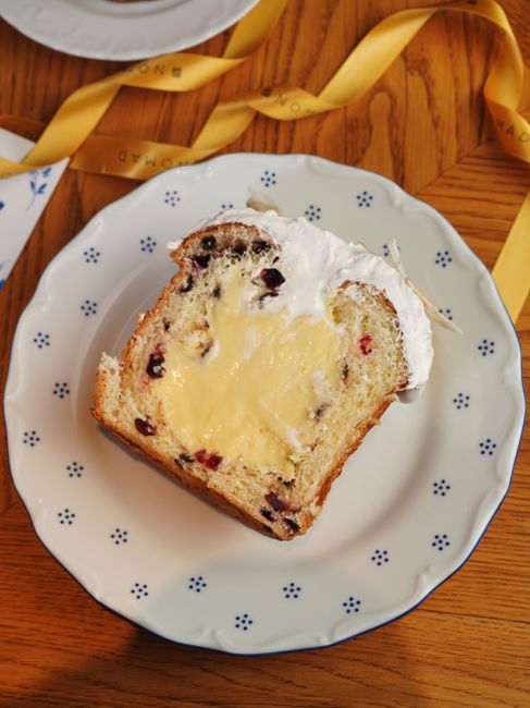 A slice of panettone with creamy filling, showcasing holiday dessert delight.