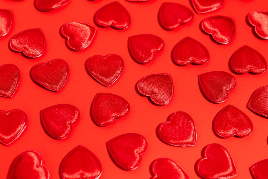 Festive red hearts on a bold red background perfect for Valentine's Day themes.