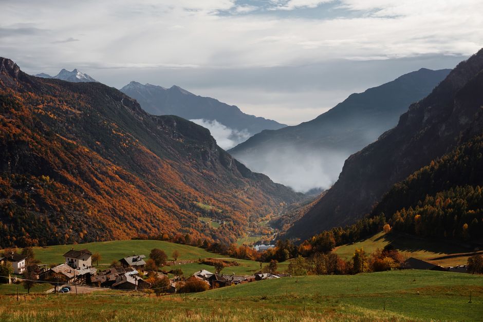 Idyllic autumn landscape in Valle d'Aosta, Italy with colorful foliage and mountain vistas.