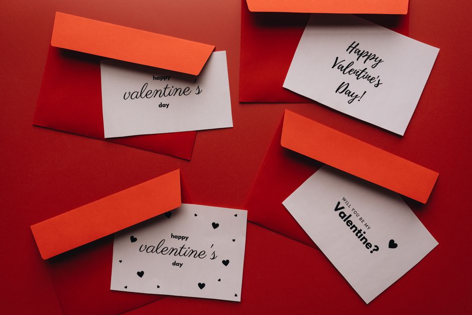 A collection of Valentine's Day cards with red envelopes on a red background.