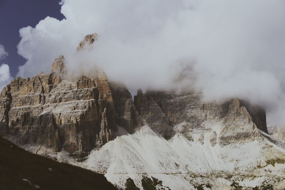 Stunning view of Dolomite mountains in Veneto, Italy, surrounded by clouds.